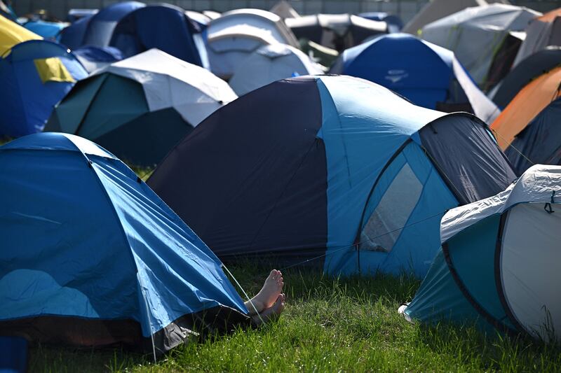 Feet stick out of a tent. Photograph: Getty Images