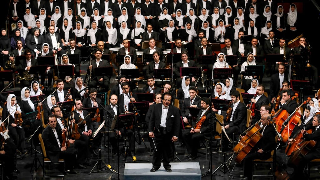 A picture from March 16th, 2015 shows Iranian conductor Ali Rahbari (centre) and the Tehran Symphony Orchestra after performing at the Vahdat Hall in Tehran. A recent performance by the orchestra was cancelled at the last minute because the musical ensemble contained women, Mr Rahbari said, adding he was told 15 minutes before the show that it could not proceed. File photograph: Amir Pourmand/AFP/Getty Images