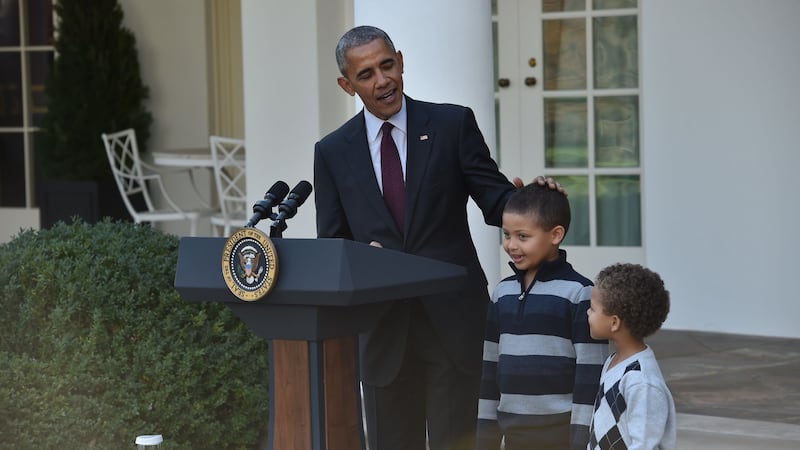 US president Barack Obama stands with his nephews, Aaron Robinson and Austin Robinson, before he pardons the national Thanksgiving turkey in the Rose Garden of the White House on Wednesday. Photograph: Nicholas Kamm/AFP/Getty Images