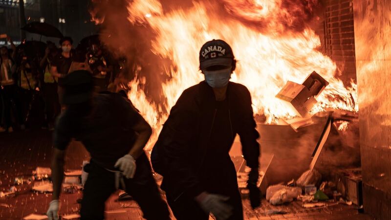 Protesters set a fire at the entrance of the MTR metro station during a demonstration at Causeway Bay district on Friday in Hong Kong. Photograph: Anthony Kwan/Getty
