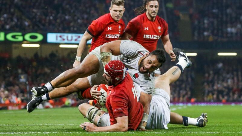 Wales’ Cory Hill scores his try despite England’s Billy Vunipola. Photograph: Ryan Byrne/Inpho