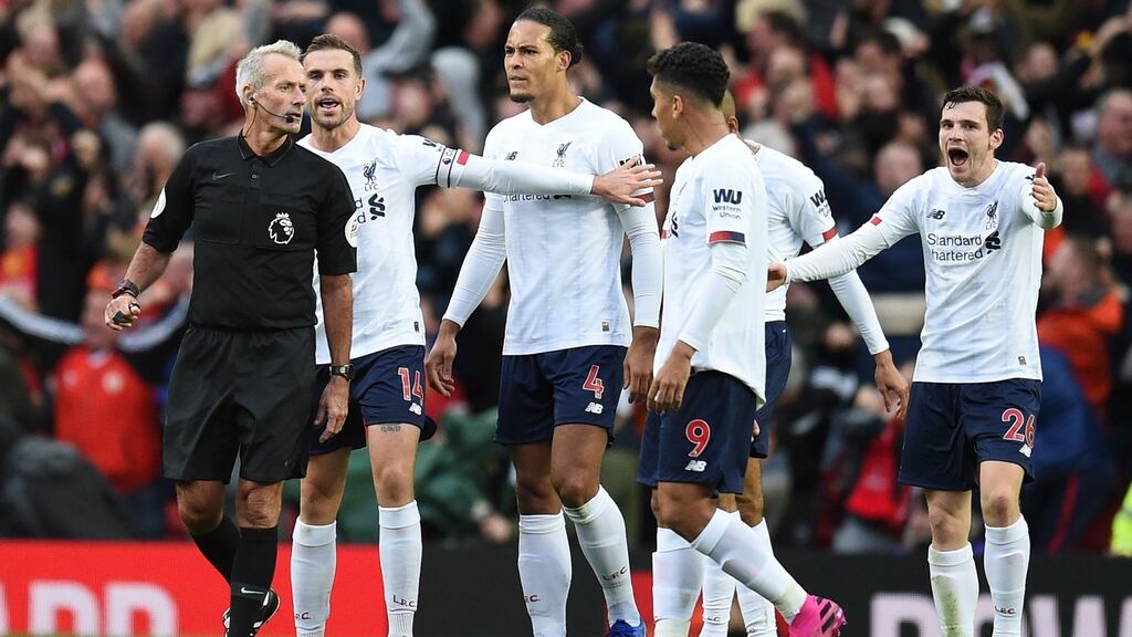 Liverpool players appeal to  referee Martin Atkinson  after he allows the opening goal for Manchester United despite a disputed challenge  on Liverpool’s striker Divock Origi in the build up. Photograph:  Oli Scarff/AFP/ Getty