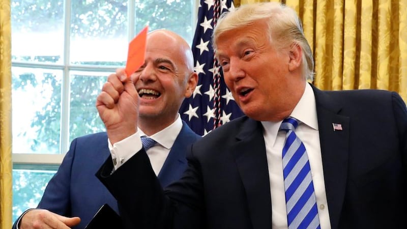 US president Donald Trump waves a red card as he meets Fifa president Gianni Infantino in the Oval Office of the White House. Photograph: Leah Millis/Reuters