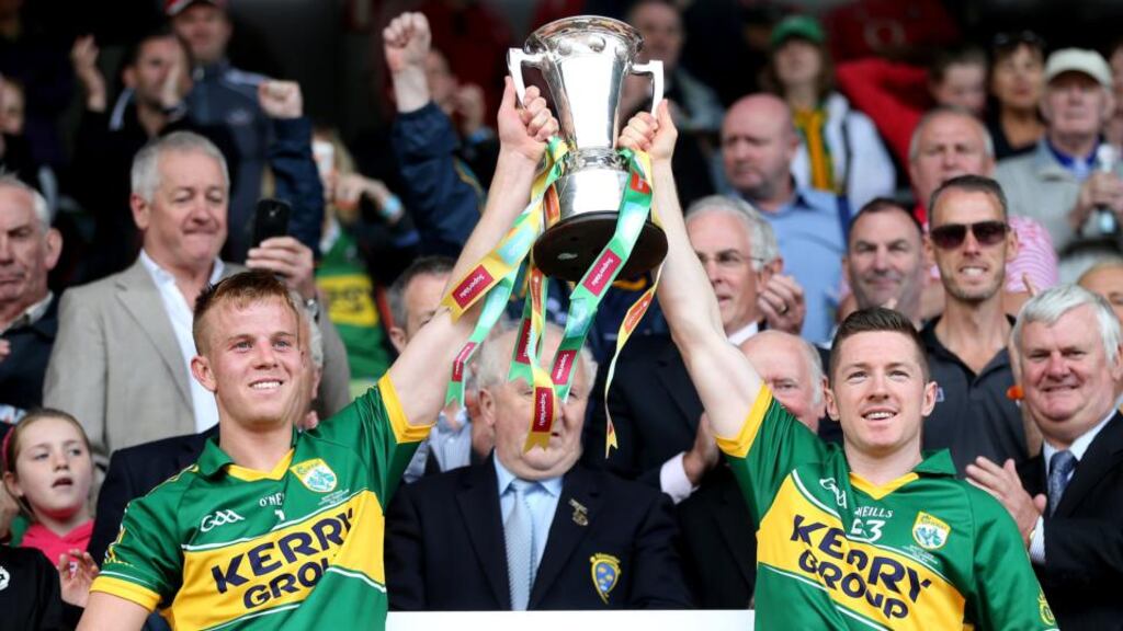 Fionn Fitzgerald and Kieran O’Leary lift the cup following Kerry’s win over Cork in the Munster SFC final at Páirc Uí Chaoimh. Photograph:  Cathal Noonan/Inpho