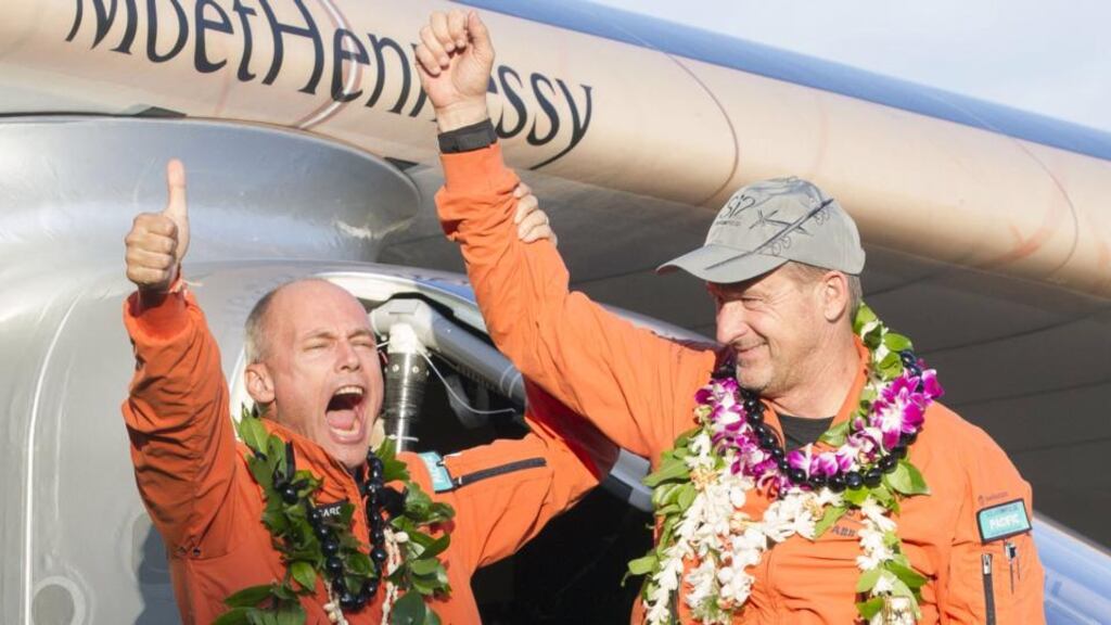 Solar Impulse 2 pilots Bertrand Piccard and Andre Borschberg, celebrate after Borschberg landed at Kalaeloa Airport, Hawaii. Photograph: Eugene Tanner/AFP/Getty Images