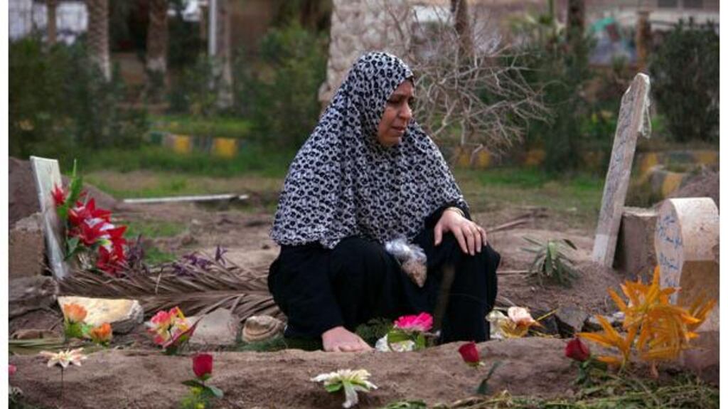 A woman mourns at the grave of her 17-year-old son, who was killed during clashes with forces loyal to Syrian President Bashar al-Assad, in Deir el-Zor yesterday. Photograph: Khalil Ashawi/Reuters