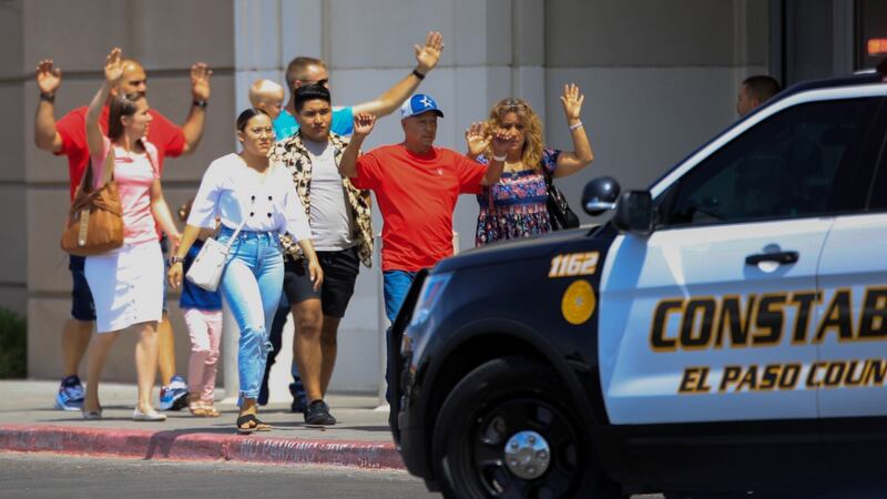 Shoppers exit with their hands up after a mass shooting at a Walmart in El Paso. Photograph: REUTERS/Jorge Salgado