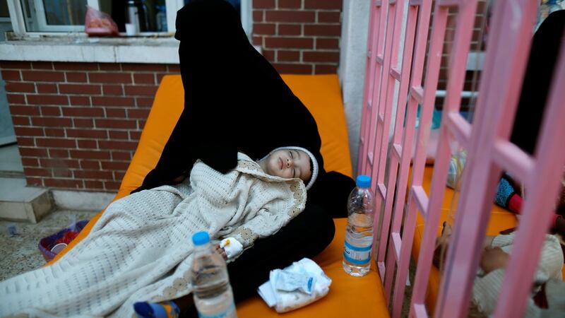 A woman holds her son who is suspected of being infected with cholera at a cholera treatment centre in Sana’aon. Photograph: Khaled Abdullah/Reuters