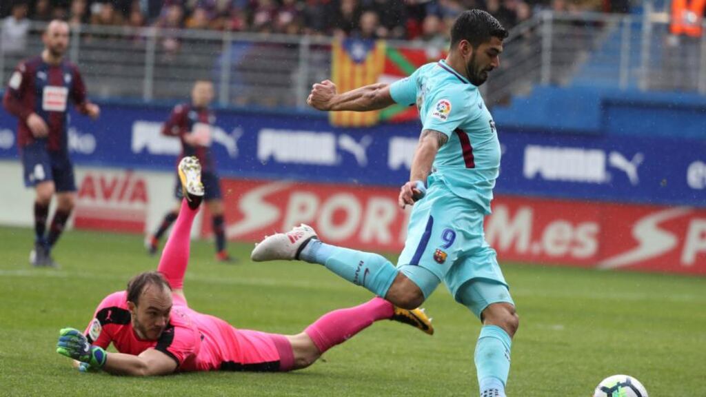 FC Barcelona’s Luis Suarez goes past Eibar’s goalkeeper Marko Dmitrovic on his way to scoring during their La Liga win. Photo: Juan Herrero/EPA