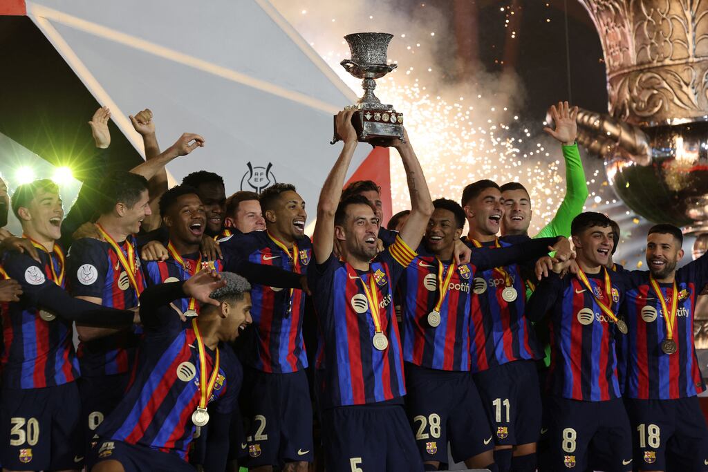 The Barcelona team celebrate with the trophy after beating Real Madrid in the final of the Super Cup. Photograph: Getty Images