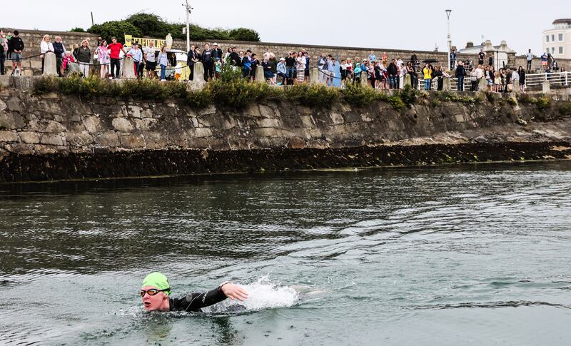 Spectators watch on from the pier as the swimmers leave the start. Photograph: Evan Treacy