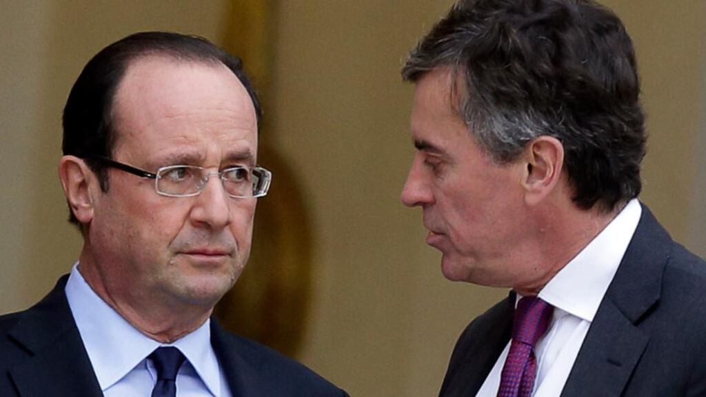 French president Francois Hollande speaks to junior minister for budget Jerome Cahuzac at the end of a government meeting about employment and the economic situation in France at the Elysee Palace in Paris in January. Photograp: Philippe Wojazer/Reuters