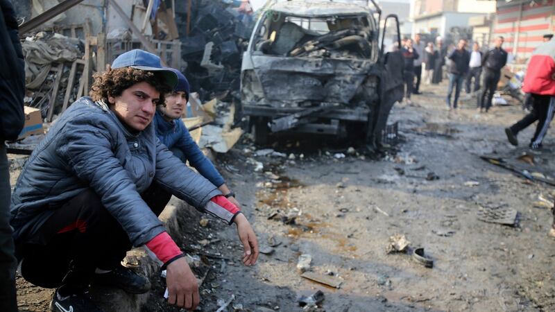 People at the scene of  a car bomb explosion at a crowded outdoor market in Baghdad on Sunday. Photograph: Karim Kadim/AP