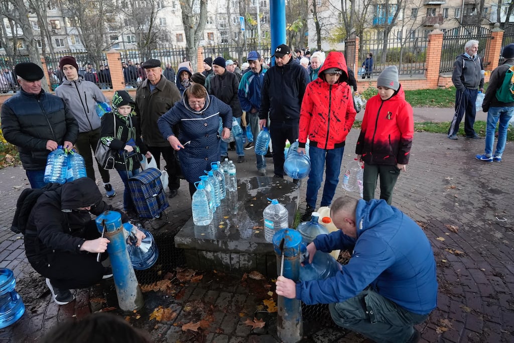 People fill containers with water from public water pumps in Kyiv, Ukraine. Photograph: Sam Mednick/AP