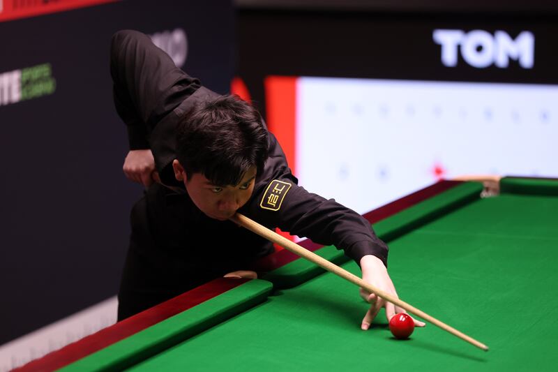 Lei Peifan of China plays a shot against Kyren Wilson of England at the Crucible. Photograph: George Wood/Getty