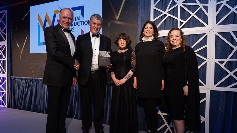 Richie Smith, business development director, presents the workplace of the year award to RKD team