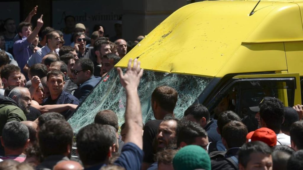 A crowd attacks a minibus carrying gay rights activists during an International Day Against Homophobia and Transphobia (IDAHO) rally in Tbilisi, Georgia. Photograph: Reuters