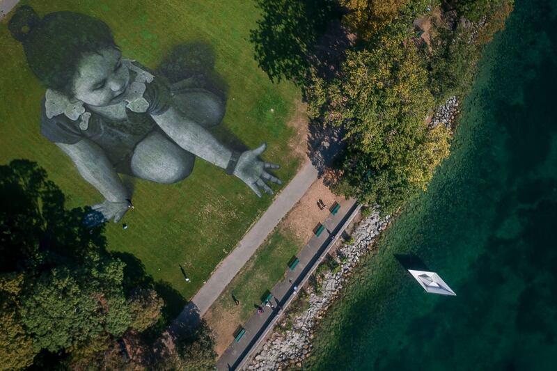 Saype: the artist’s giant fresco in Geneva in aid of SOS Méditerranée. Photograph: Fabrice Coffrini/AFP/Getty
