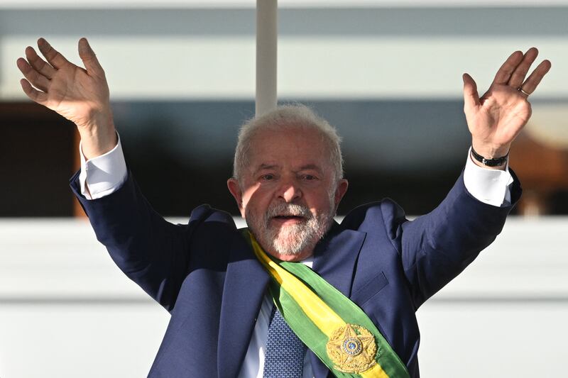 Brazil's new president, Luiz Inácio Lula da Silva, waves at supporters at Planalto Palace after his inauguration ceremony in Brasília on Sunday. Photograph: Evaristo Sa/AFP via Getty Images
