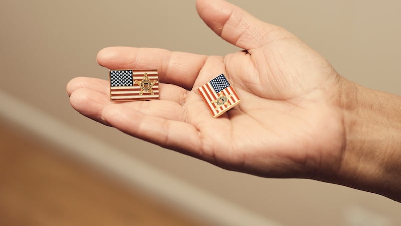 Victorina Morales holds American flag pins with a Secret Service logo, which she said she was asked to wear during US president Donald Trump’s visits to the Trump National Golf Club in Bedminster, New Jersey. Photograph: Christopher Gregory/New York Times