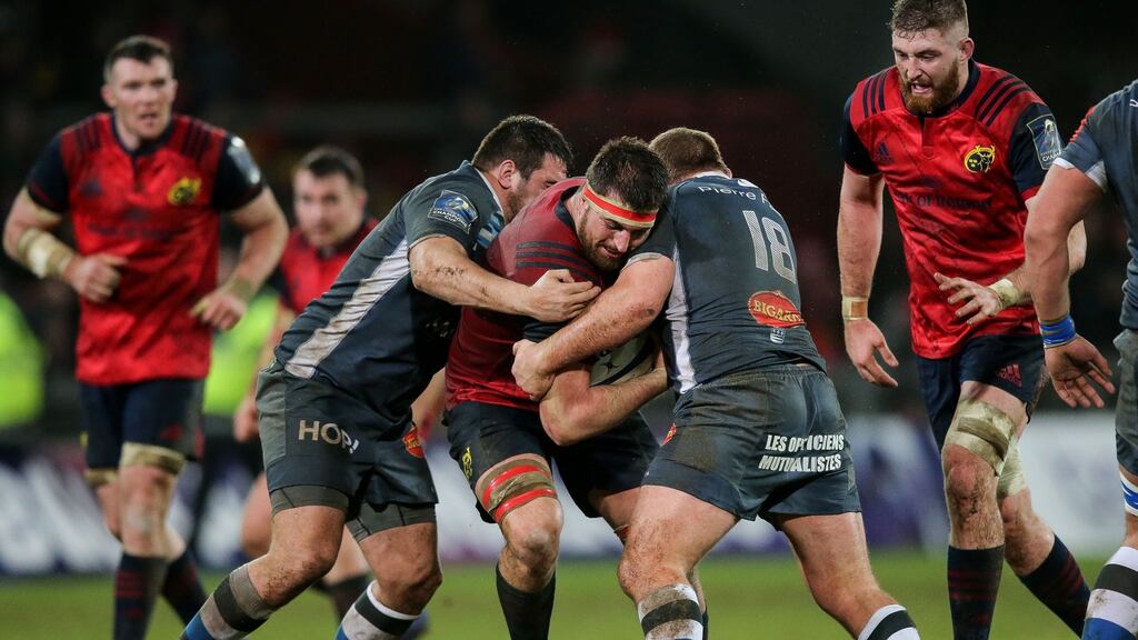 Munster’s Jean Kleyn is tackled by Castres’ Tudor Stroe and Daniel Kotze at Thomond Park. Photograph: Gary Carr/Inpho