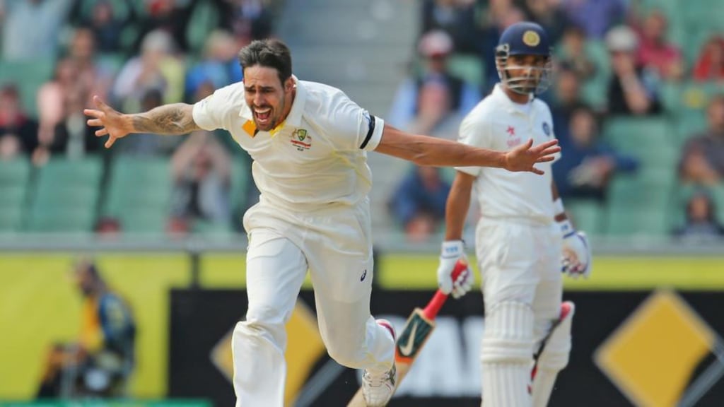 Mitchell Johnson celebrates after bowling Cheteshwar Pujara on the final day of the drawn test match between Australia and India at the MCG