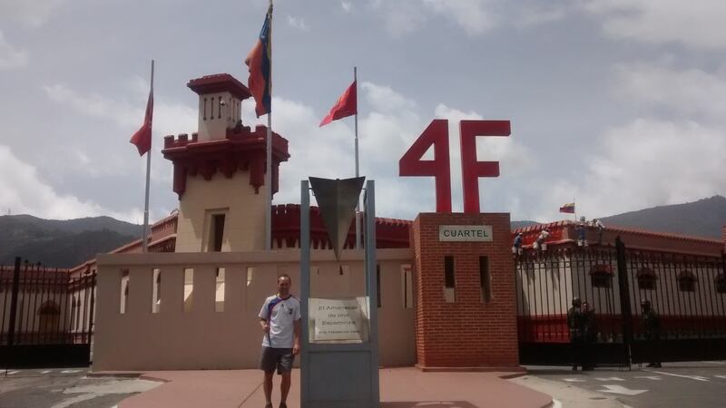 Brendan Corrigan in Barrio 23 de Enero, outside a building where Chávez’s body is supposedly kept.