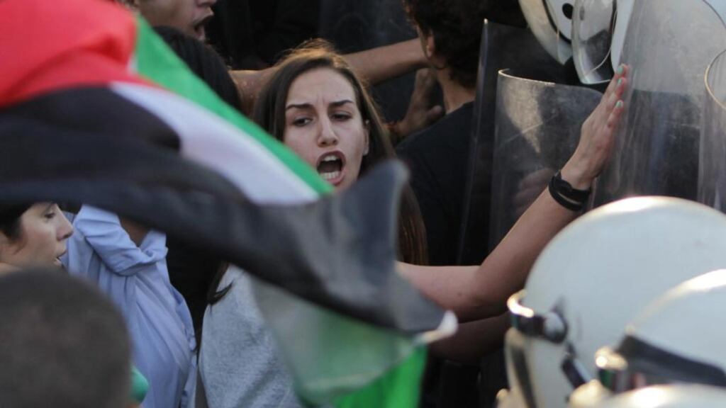 Palestinian riot police officers scuffle with protesters during a demonstration in the West Bank city of Ramallah. Photograph: Abbas Momani/AFP/Getty