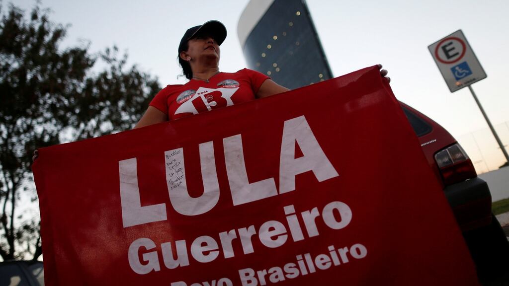 Supporters of Luiz Inacio Lula da Silva, display banners with text written in Portuguese that read “Free Lula” during a protest in front of the Superior Electoral Court, in Brasilia, Brazil on Friday. Photograph: Adriano Machado/Reuters