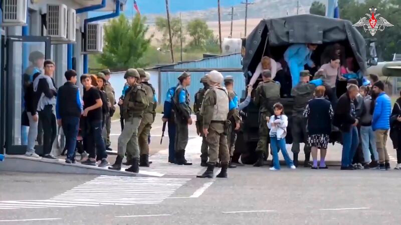 Russian peacekeepers help ethnic Armenians leave a truck at a camp in Nagorno-Karabakh. More than 5,000 residents have taken shelter there. Photograph: AP