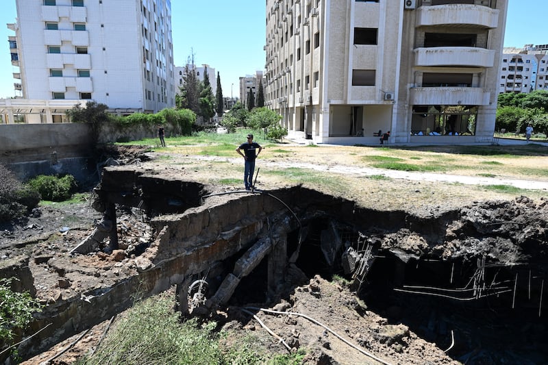 A man stares at damage caused to a building following an Israeli strike in the neighbourhood of Kafr Sousse in Damascus early on Sunday. Photograph: Louai Beshara/AFP via Getty