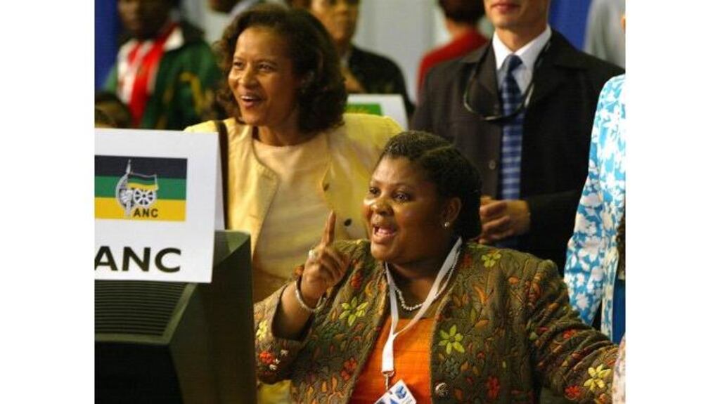ANC members celebrate as they watch the election results board at the Independent Electoral Commission centre in Pretoria, South Africa, yesterday. Photograph: Themba Hadebe/AP