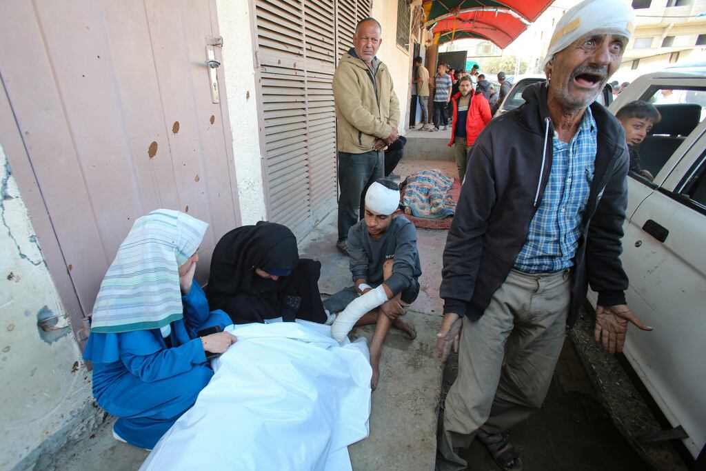 An injured Palestinian man reacts as others surround the body of a victim killed an Israeli strike on the Nuseirat refugee camp, in front of the al-Aqsa Martyrs hospital in Deir el-Balah in the central Gaza Strip. Photograph: Eyad Baba/AFP via Getty Images