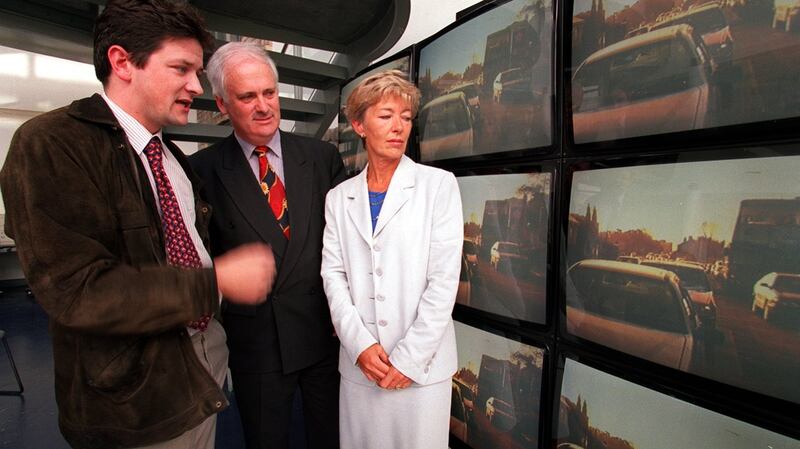 Conor Faughnan of AA Roadwatch watches a video on Dublin traffic with then Fine Gael leader John Bruton and Oliva Mitchell, spokesperson on Dublin Traffic in 2002