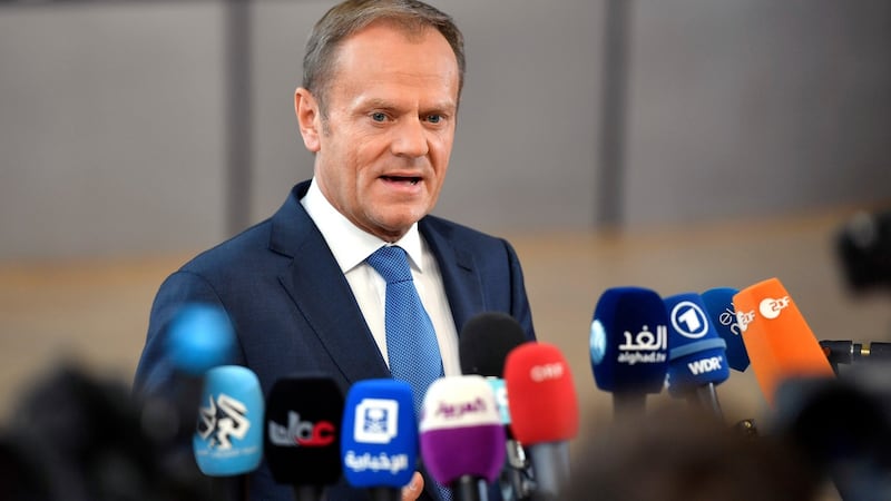 European Council president Donald Tusk speaks with the media as he arrives for an EU summit at the Europa building in Brussels on Saturday. Photograph: AP