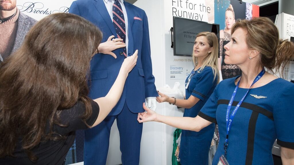 United Airlines employees examining  Brooks Brothers’ uniform prototype. Photograph: Wayne Slezak