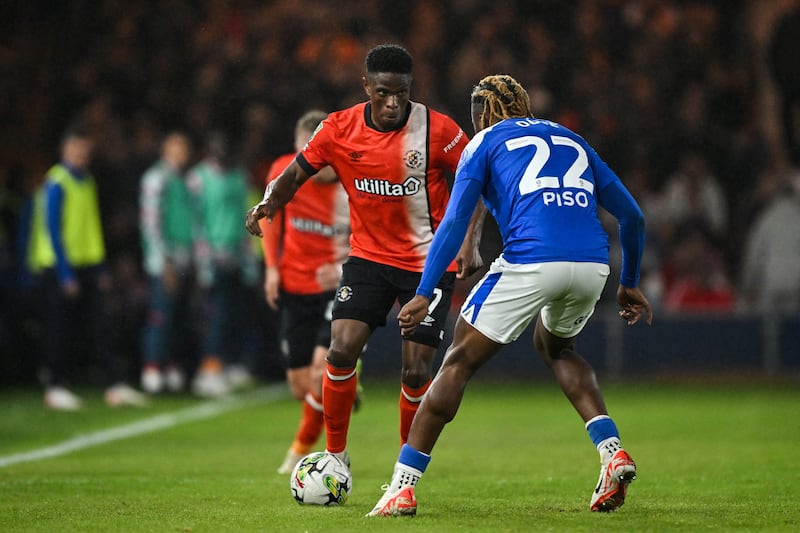 Luton Town's Irish midfielder Chiedozie Ogbene (in orange) and Gillingham's Irish midfielder Shadrach Ogie during an English League Cup match at Kenilworth Road stadium in Luton, Bedfordshire, on August 29th, 2023. Photograph: Justin Tallis/AFP