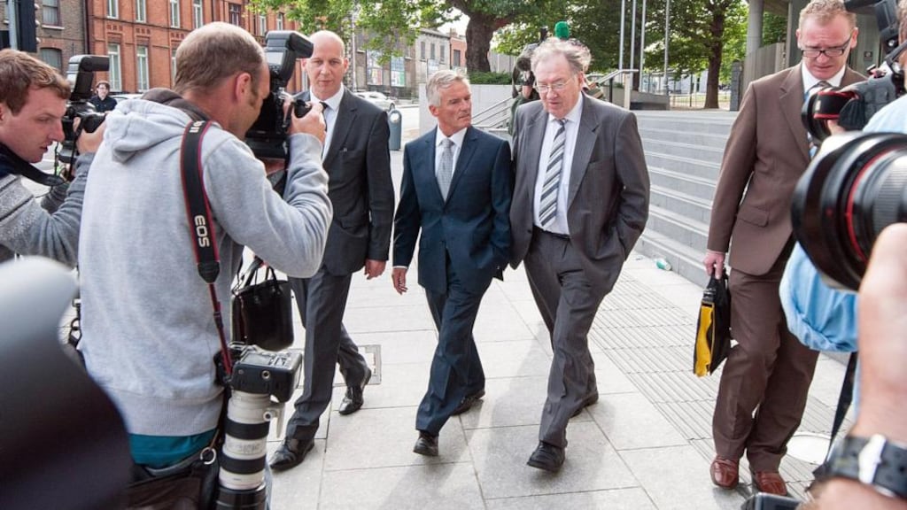 Former junior minister of State Ivor Calley (centre) with members of his legal team outside Dublin Circuit Court yesterday. Photograph: Collins Courts