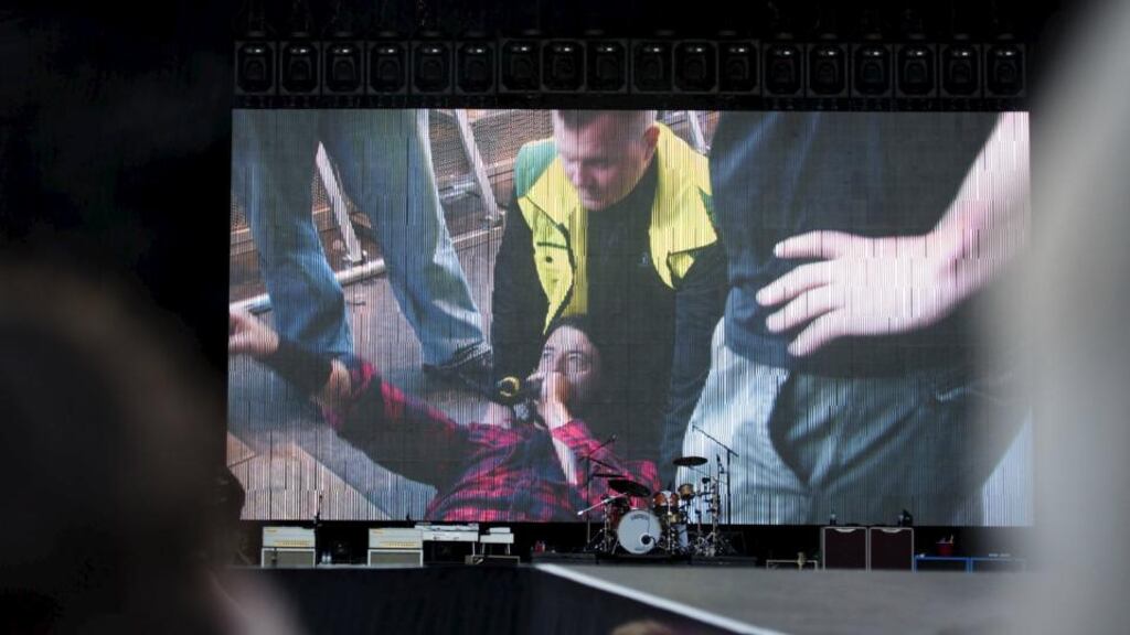 Foo Fighters band member Dave Grohl is seen on a big screen talking on a microphone after falling from the stage during the band’s concert at Nya Ullevi in Gothenburg, Sweden. Photograph: Erik Abel/TT News Agency/Reuters