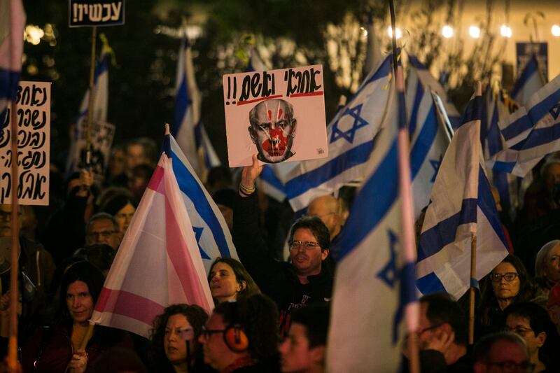 Protesters in Tel Aviv hold signs and flags during a demonstration against Israeli prime minister Benjamin Netanyahu and the Israeli government. Photograph: Amir Levy/Getty Images