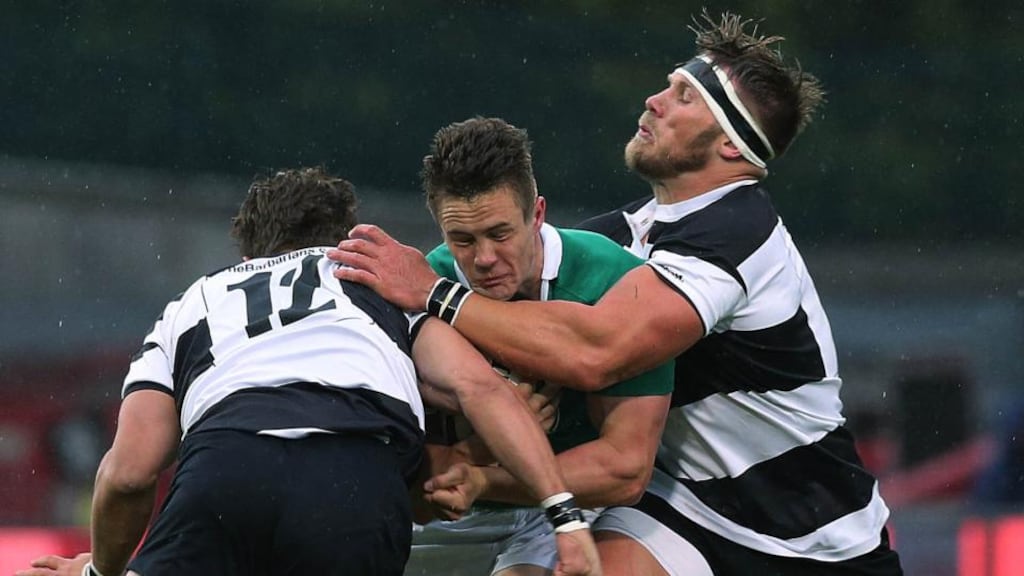 Barbarians’ Wynand Oliver and Gerhard Vosloo tackle Ireland’s Colm O’Shea during the friendly match at Thomond Park.