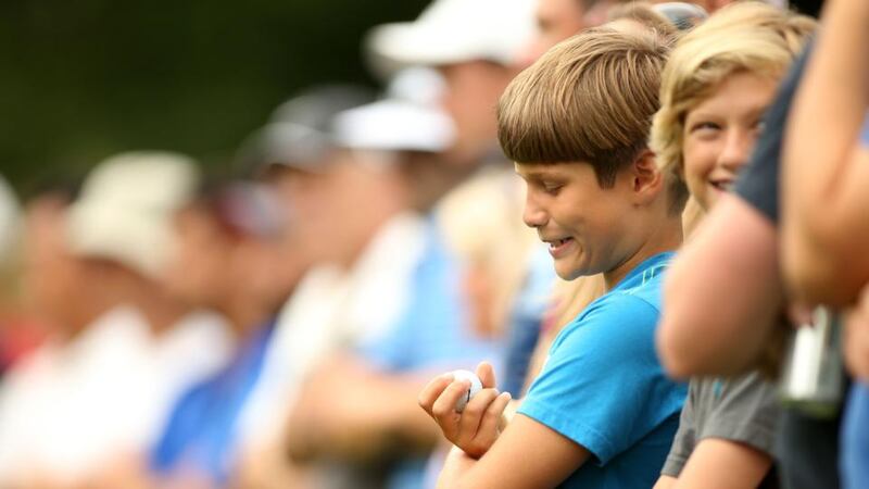 Jackson Ward (9) of West Orange, New Jersey, holds a ball rolled to him by Rory McIlroy on the fifth tee during the third round of The Barclays at The Ridgewood Country Club in Paramus, New Jersey. Photograph: Darren Carroll/Getty Images