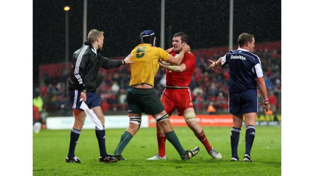 Munster's Peter O'Mahony and Rob Simmons of Australia get to grips with each other during the first half at Thomond Park. Photograph: James Crombie/Inpho