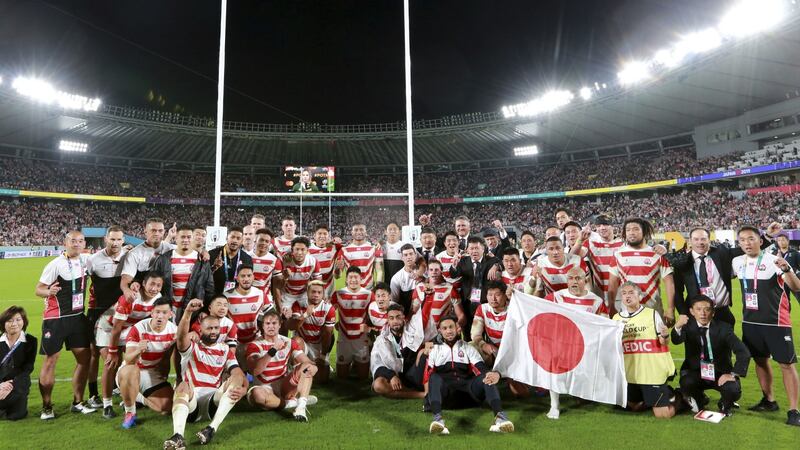 The Japanese team applaud their fans after the match. Photo: Eugene Hoshiko/AP Photo