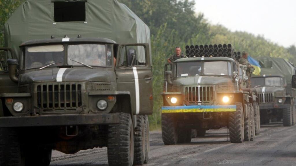 Ukrainian servicemen are seen inside army vehicles on a road in Donetsk region. Photograph: Valentyn Ogirenko/Reuters