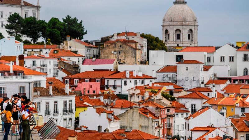 Tourists take pictures from the Portas do Sol viewpoint in the Alfama neighbourhood in Lisbon ahead of the Champions League finals. Photo: Patricia De Melo Moreira/AFP via Getty Images