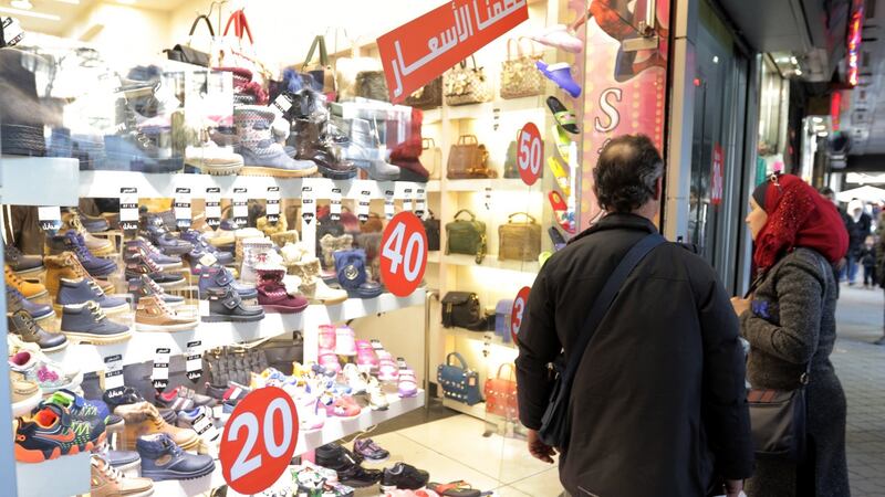“Normality” continues: Syrians look through a shop window at al-Salhiyah Market in Damascus, Syria, on Monday. The Syrian army is preparing for a military offensive to drive militants out of Eastern Ghouta near Damascus. Photograph: Youssef Badawi/EPA
