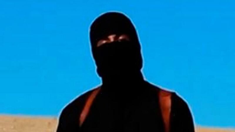 A frame grab from a video released by the Islamic State  showing a militant before he apparently killed British aid worker David Haines.