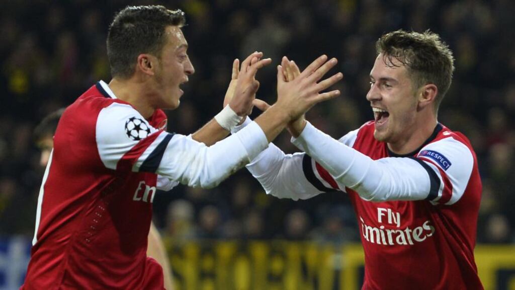 Arsenal’s Welsh midfielder Aaron Ramsey (R) celebrates scoring a goal with team-mate Mesut Ozil.  Photo: Odd Andersen/Getty