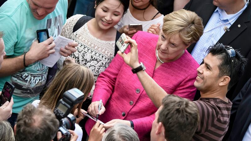 Angela Merkel poses for a selfie with a supporter in Berlin last month. Photograph: Clemens Bilan/EPA